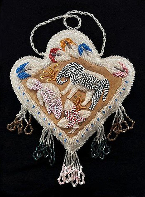 A pincushion with images of elephant and beaver