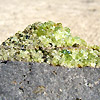 Peridot with minor pyroxene on vesicular basalt